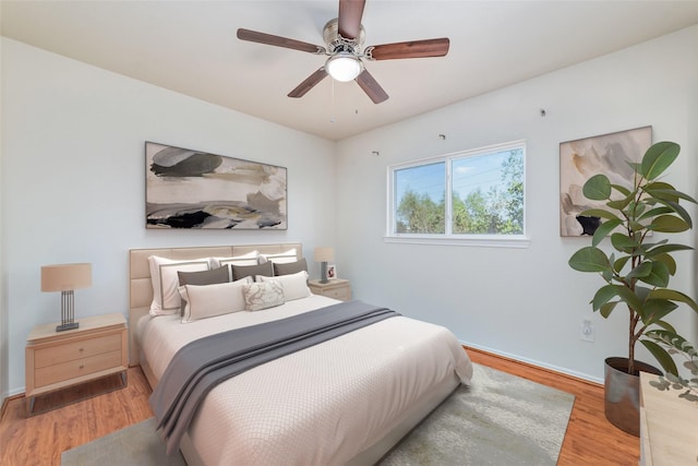 bedroom with ceiling fan and light hardwood / wood-style floors