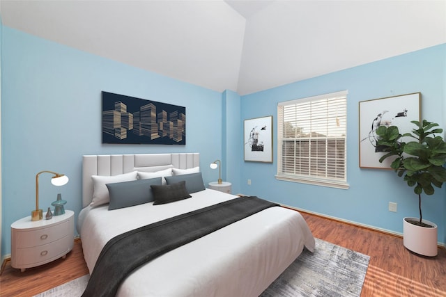 bedroom featuring hardwood / wood-style flooring and vaulted ceiling