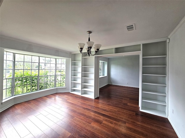 interior space featuring a chandelier, ornamental molding, built in features, and dark wood-type flooring