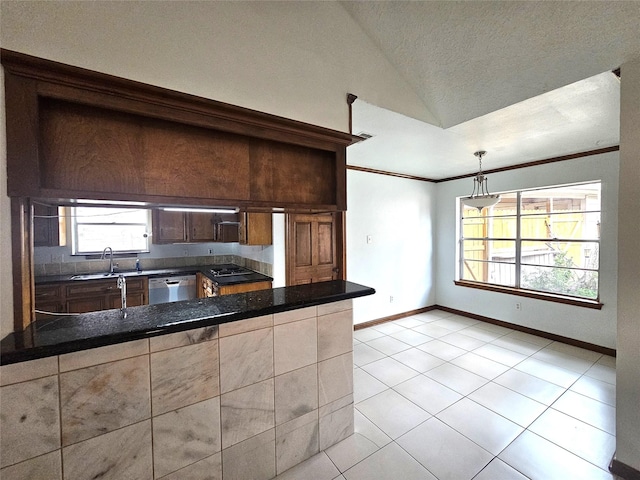 kitchen with dishwasher, sink, pendant lighting, vaulted ceiling, and light tile patterned floors