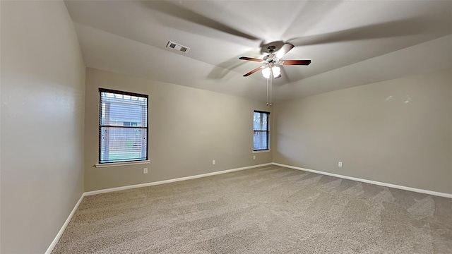 carpeted spare room featuring ceiling fan and lofted ceiling