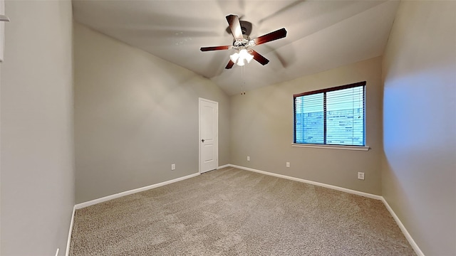 spare room with carpet floors, vaulted ceiling, and ceiling fan