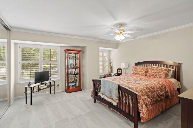 carpeted bedroom featuring ceiling fan and crown molding