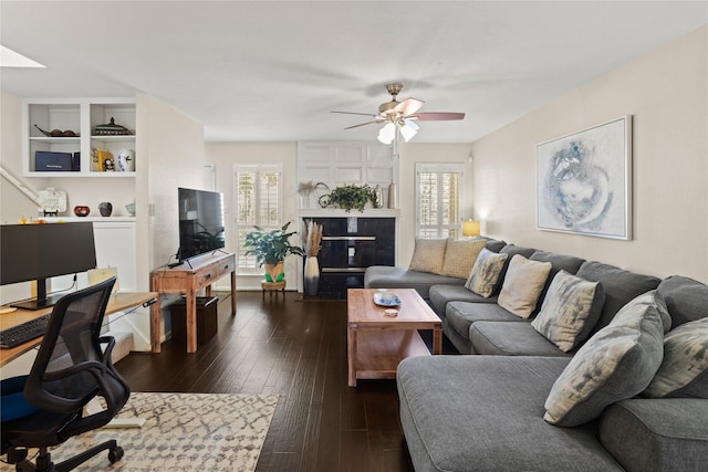 living room with ceiling fan and dark hardwood / wood-style flooring