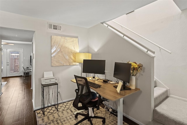 home office with wood-type flooring and french doors