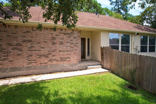 entrance to property featuring a yard