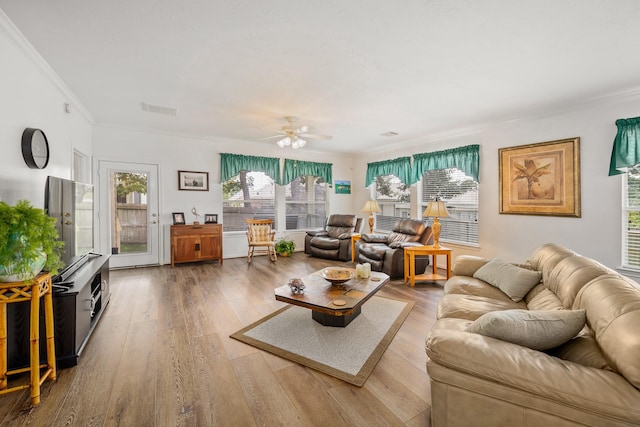 living room with hardwood / wood-style floors, ceiling fan, and crown molding