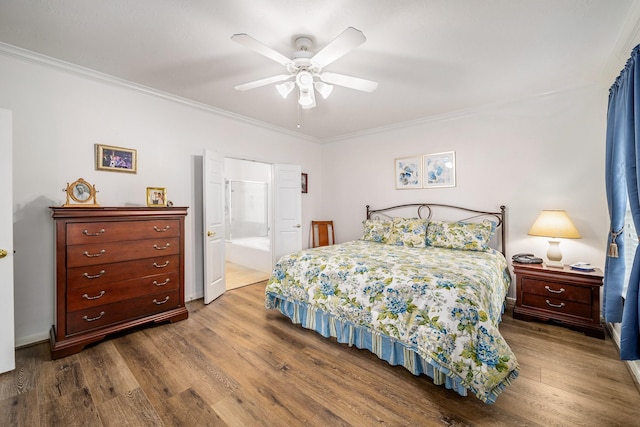 bedroom with hardwood / wood-style floors, connected bathroom, ceiling fan, and ornamental molding