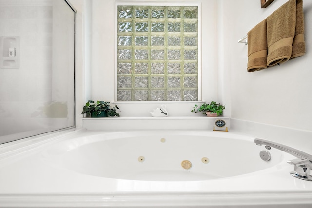 bathroom with a tub to relax in