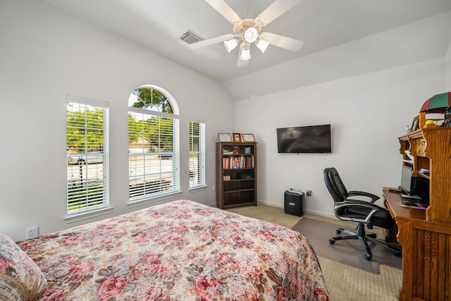 carpeted bedroom with ceiling fan and vaulted ceiling