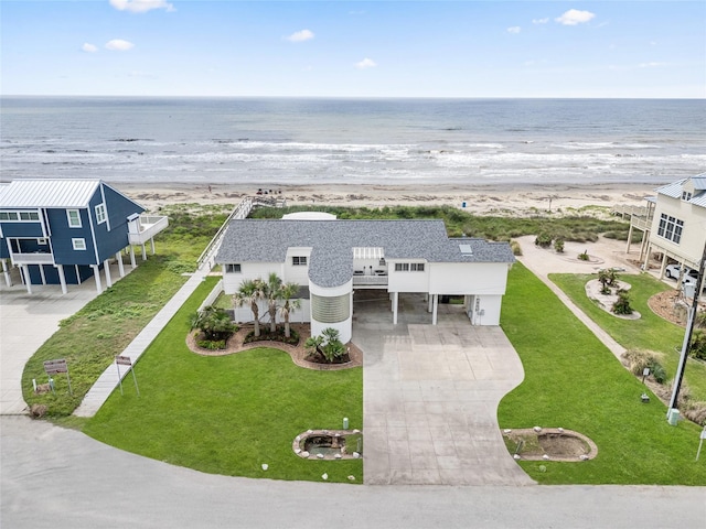 aerial view with a water view and a view of the beach