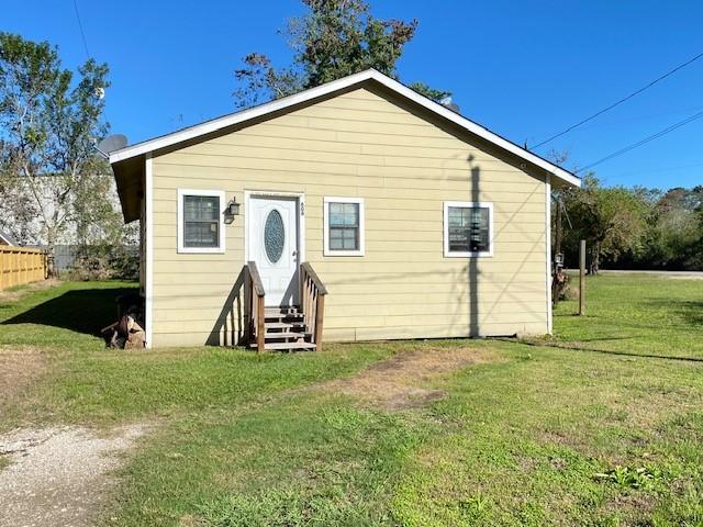 back of property featuring a lawn