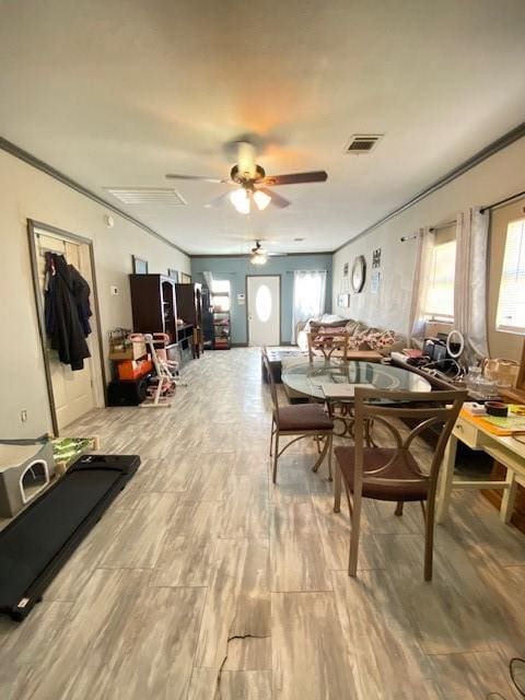 dining room with ceiling fan and ornamental molding