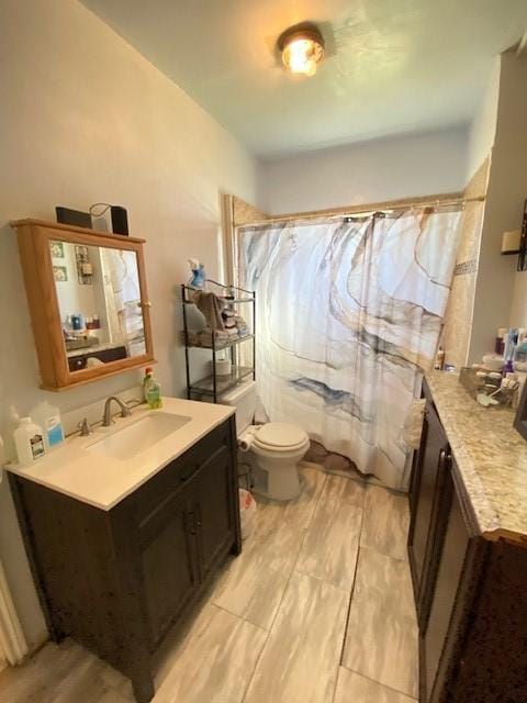 bathroom with walk in shower, vanity, and toilet