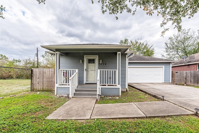 view of front of house with a front yard, a porch, and a garage