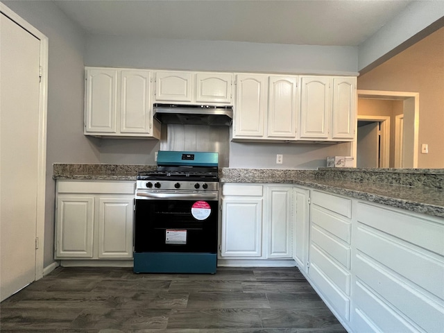 kitchen with under cabinet range hood, dark wood-style flooring, stainless steel range with gas stovetop, and white cabinets