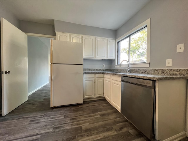 kitchen featuring a sink, stainless steel dishwasher, dark wood-style floors, freestanding refrigerator, and white cabinets