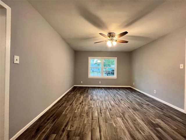 unfurnished room featuring dark wood finished floors, ceiling fan, and baseboards