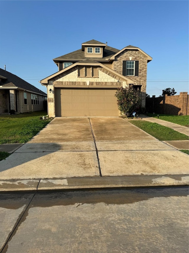 view of front of house with a front yard and a garage