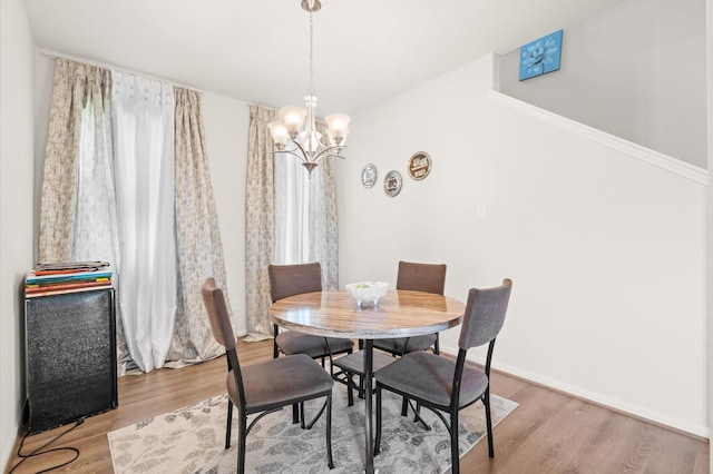 dining room with wood-type flooring and a chandelier