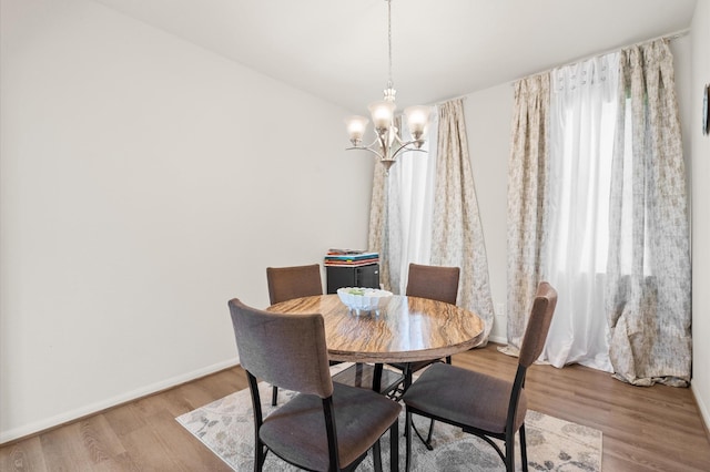 dining room featuring a notable chandelier and light hardwood / wood-style floors