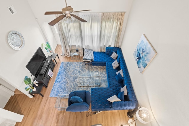 living room with hardwood / wood-style flooring and ceiling fan