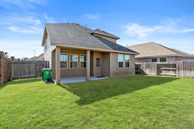 rear view of house featuring a patio area and a yard