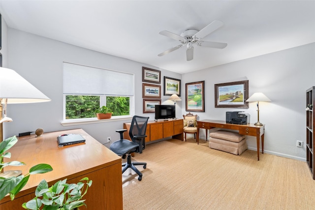 carpeted home office featuring ceiling fan