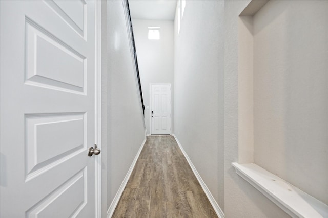 corridor with hardwood / wood-style floors