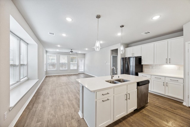 kitchen featuring appliances with stainless steel finishes, white cabinetry, pendant lighting, and sink