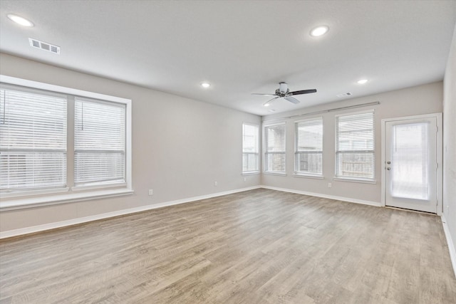 empty room with ceiling fan and light wood-type flooring