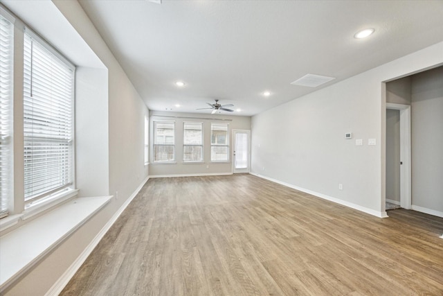 unfurnished living room with ceiling fan and light hardwood / wood-style floors