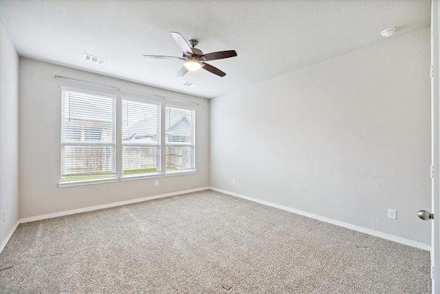 carpeted empty room with ceiling fan and a healthy amount of sunlight