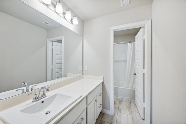 full bathroom featuring vanity, shower / bath combo, and toilet