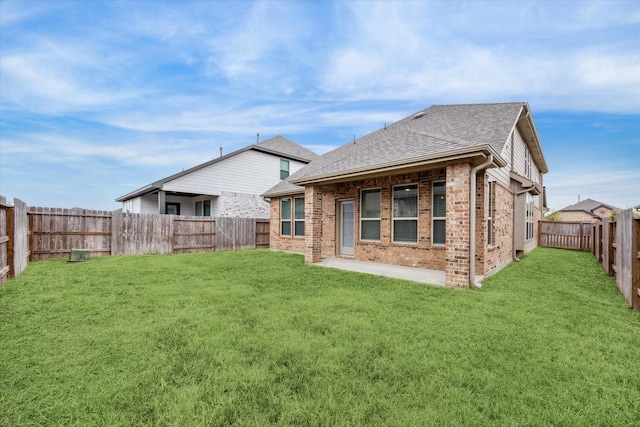 rear view of house featuring a lawn