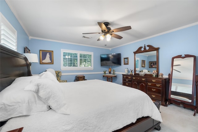 carpeted bedroom featuring ceiling fan and crown molding