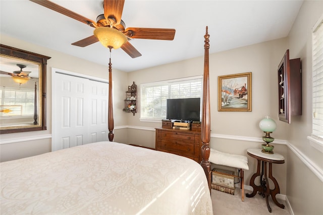 carpeted bedroom featuring a closet and ceiling fan