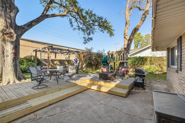 view of patio with a pergola, grilling area, and a wooden deck