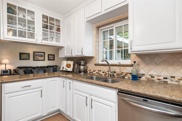 kitchen featuring white cabinets, dishwasher, decorative backsplash, and sink