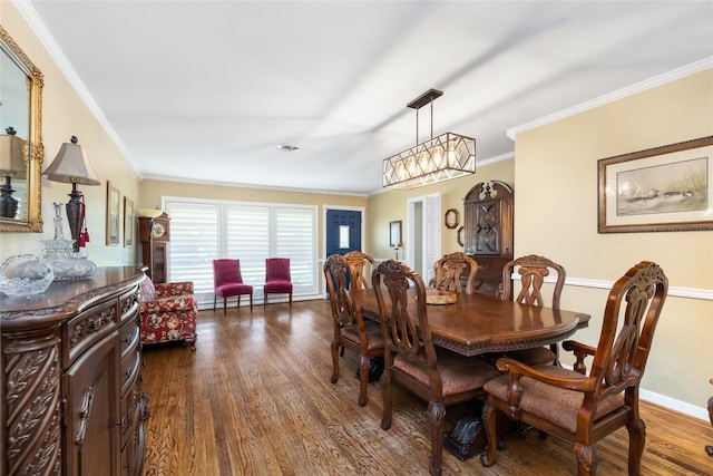 dining room featuring dark hardwood / wood-style floors and ornamental molding