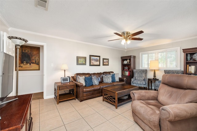 tiled living room with ceiling fan and crown molding