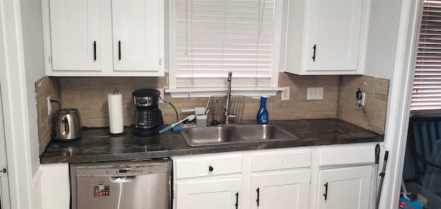 kitchen with backsplash, white cabinetry, and stainless steel dishwasher