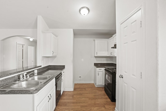 kitchen with kitchen peninsula, sink, black appliances, white cabinets, and dark hardwood / wood-style floors