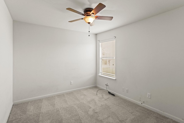 empty room with ceiling fan and light colored carpet