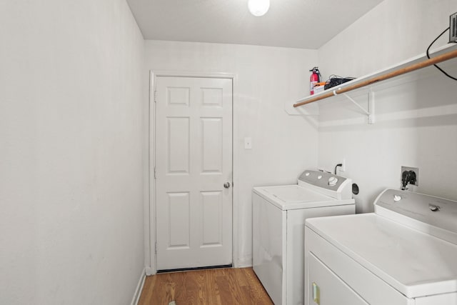 laundry area featuring hardwood / wood-style flooring and independent washer and dryer