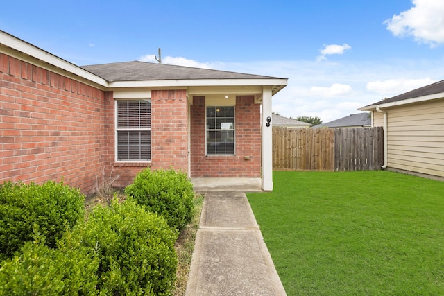 doorway to property featuring a yard