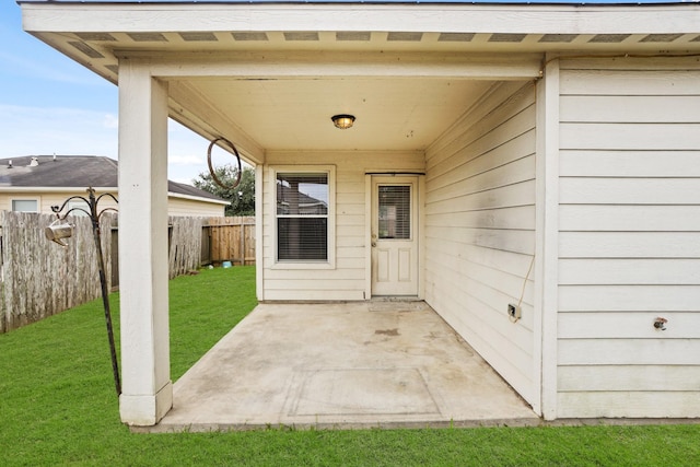 property entrance with a patio area and a yard