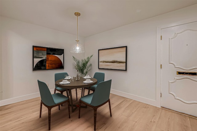 dining space with light hardwood / wood-style floors