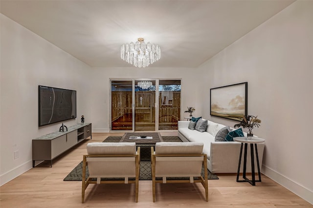 living room with light wood-type flooring and an inviting chandelier