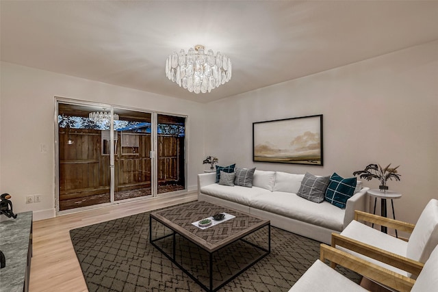 living room featuring wood-type flooring and a notable chandelier